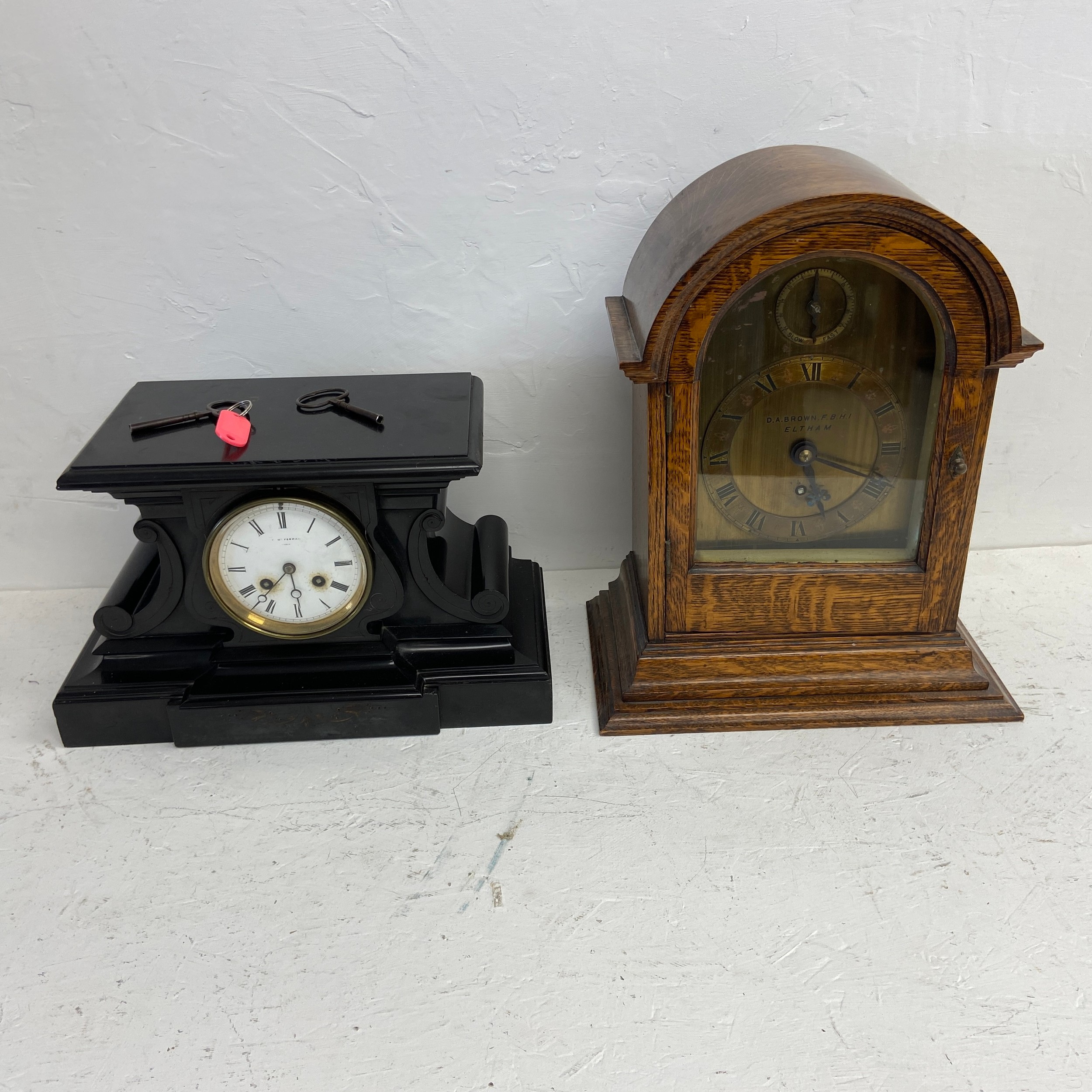 A 19th century slate mantel clock and an oak cased mantel clock marked D A Brown. H.39 (Tallest).