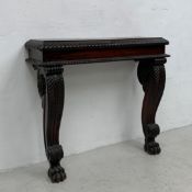 A Regency rosewood console table having a rectangular top with lobed edge raised on a pair of