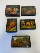 A collection of five lacquered Russian papier mache dressing table boxes with hand painted and