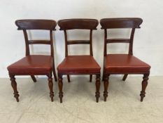 Three early Victorian mahogany bar back dining chairs on turned tapering supports. (Low cost in-