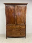 A 19th century mahogany linen press fitted with slides above two short and three long drawers on