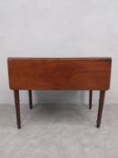 A 19th century mahogany drop flap Pembroke table with frieze drawer on turned tapering legs. H.66.