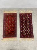 Two small Bokhara mats with repeating medallions on burgundy grounds. 120x56cm.