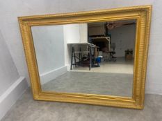 A large contemporary giltwood and gesso wall mirror with bevelled plate. 95x120cm.