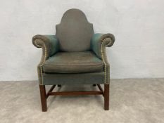 A Georgian mahogany framed library tub armchair on square stretchered supports. H.96cm.