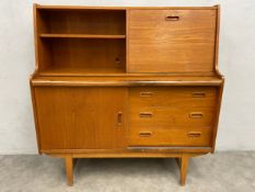 A mid-century teak side cabinet with pull out slide. H.111 W.107 D.38cm. (Small cut to back as
