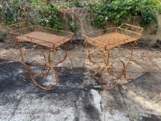 A pair of contemporary wrought metal garden side tables of trolley form with a faux rust finish.