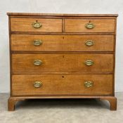 A Georgian mahogany chest of two short over three long graduating drawers raised on shaped bracket