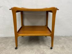 A mid-century Danish teak drink trolley with shaped tray top raised on flat tapering supports on
