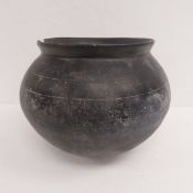 An Indian clay Matka or water vessel of globular form with a short everted rim tapering down to a