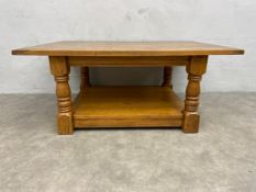 A Jacobean style oak low table with maker's plaque. H.46 W.107 D.76cm.