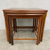 A mid-century nest of three Danish teak tables by E.W. Bach for Mobelfabrikken Toften with maker's