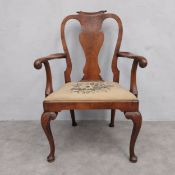 An 18th century Queen Anne style walnut open armchair with shaped back and carved c-scroll arms over