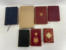 A collection of seven books, to include King James bible, etc.