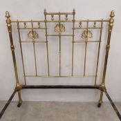 A Victorian brass bedstead with peacock fan decoration. With base to take a standard double