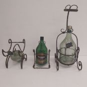 Three vintage wrought iron wine bottle holders with hinged pouring mechanism along with three