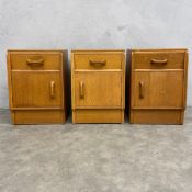 Three mid-century light oak bedside cabinets stamped E Gomme, High Wycombe. H.53 W.37 D.33cm.