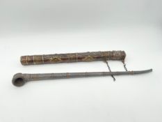 A 19th century white metal Ottoman chibouk or smoking pipe together with a Tibetan brass and