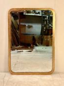 A contemporary gilt metal wall mirror in a rounded rectangular frame. 98x68cm.