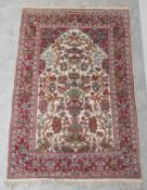 A Persian rug with scrolling foliate decoration on a biscuit ground within naturalistic flowerhead