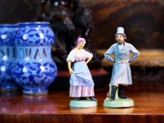A PAIR OF BISQUE PORCELAIN RUSSIAN FIGURES