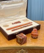 A LATE 19TH CENTURY AGATE DESK SET IN LEATHER CASE
