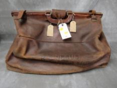A LARGE EARLY 20TH CENTURY MILITARY INTEREST LARGE GLADSTONE LEATHER HOLDALL BAG, by H. Greaves of