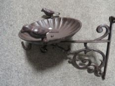 **A wall mounted metal bird bath**