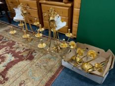 A pair of modern gold chandeliers together with wall lights