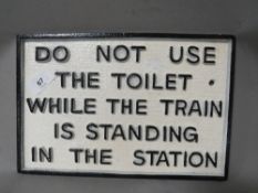**A cast toilet sign**