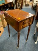 A 19th century mahogany two drawer side table raised on turned supports