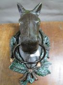 **A cast metal horse head towel holder**