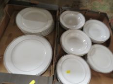 Two trays of gilded white ceramic dinnerware