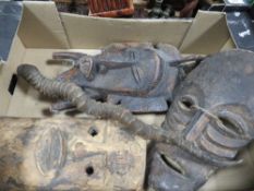 Three tribal wall masks and an antelope horn