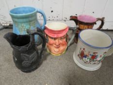 A small collection of jugs and tankards to include a frog jug