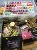 A box of new nail varnishes together with a box of make-up