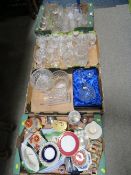 Three trays of crystal and cut glass to include vases and decanters together with a tray of assorted