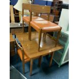 A retro dining table and four chairs and a sideboard