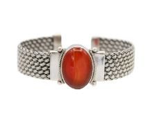 A silver with carnelian woven open bangle.