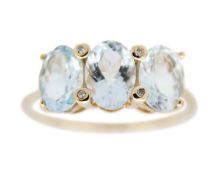 A 9k gold three-stone aquamarine ring.
