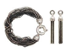 A two-tone silver multi-row chain bracelet with a matching pair of tassel stud earrings.