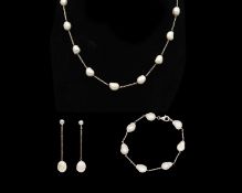 A set of baroque freshwater pearl necklace, bracelet, and earrings set in silver.