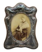 A modern silver-mounted photograph frame in Victorian style.