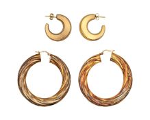 Two pairs of gold hoop earrings.