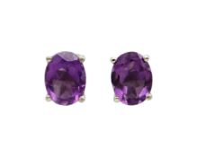 A pair of silver amethyst stud earrings.