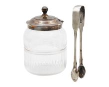 A George V silver lidded cut glass condiment jar, and a George IV silver pair of tongs.