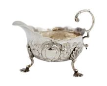 A George II silver sauce boat with foliate embossed decoration.