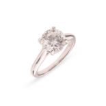 A diamond solitaire ring, composed of a round brilliant diamond, measuring approximately 8.1mm, with