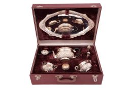 An Indian five-piece tea set, in fitted case, comprising a teapot, sugar basin, milk jug, tea tray s