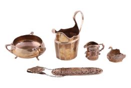 An Arts and Crafts silver three-handled bowl, hand-hammered finish with three stylised leaf-mounted 